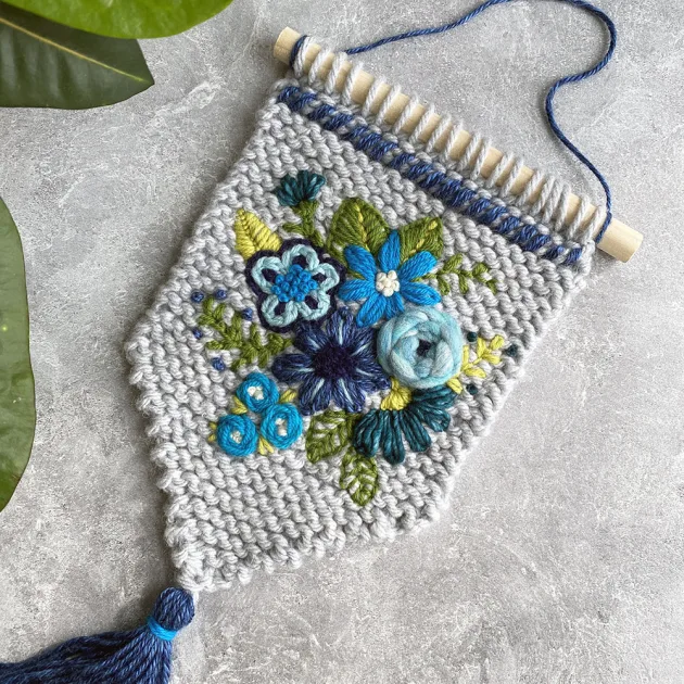 gray and blue embroidered tapestry